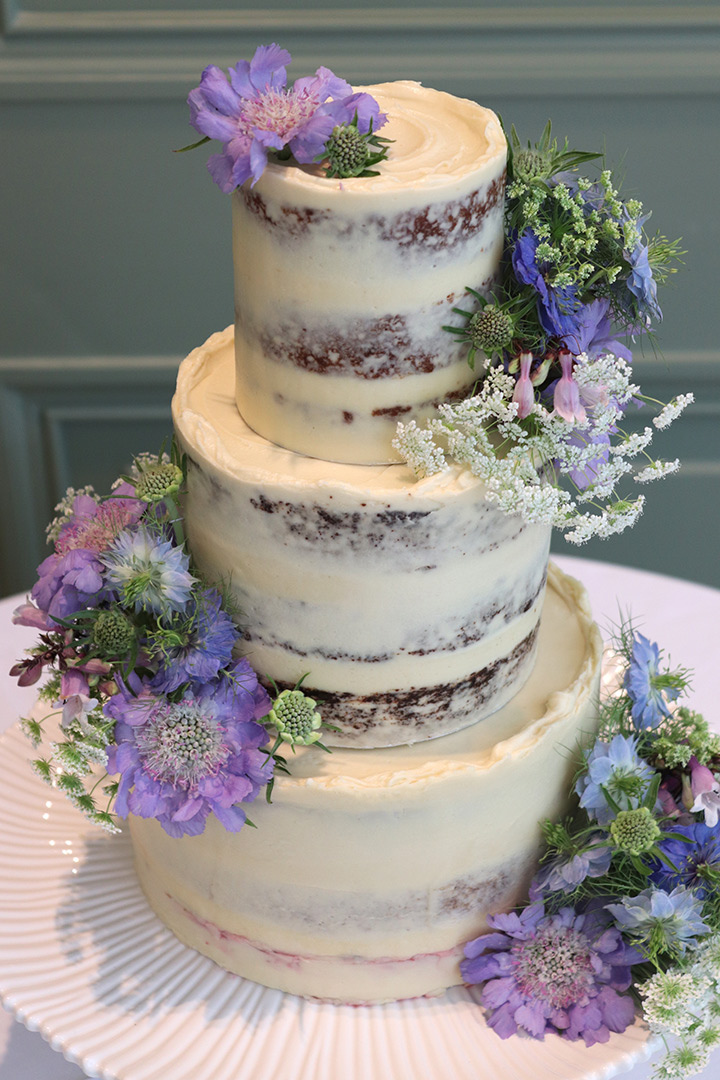 A vegan wedding cake in the Terrace Room at the Hurlingham Club. Peanut Butter & Banana Blondie, Mocha Choc, and Madagascar Vanilla with raspberries. All ingredients glutenfree & vegan. Flowers by thefloraleditor.com. Price includes delivery and assembly at your London venue