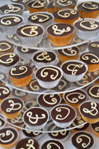 Gluten-free, dairy-free wedding cupcakes: Rich chocolate & almond cupcakes, made with organic Fairtrade dark chocolate and ground almonds and Appleton Jamaica Rum. Topped with dark chocolate ganache and dairy-free white 'chocolate' initials. Collection or delivery in London. All ingredients gluten free and dairy free