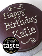 Award-winning rich chocolate cake made with gluten free ingredients: organic ground almonds and Fairtrade dark chocolate and Appleton Jamaica Rum. Covered with dark chocolate ganache and decorated with piped birthday message in organic white chocolate. All ingredients gluten-free. Available diary free