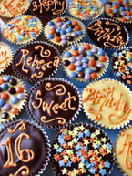 Rich chocolate cupcakes for a gluten-free teenage birthday. Made with organic Fairtrade dark and white chocolate and ground almonds. Topped with ganache and decorated with gluten free sprinkles. Delivery available in London. These cupcakes can be posted. All ingredients glutenfree