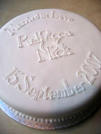 A beautifully moist rich fruit cake for your wedding day. Gluten-free, made with organic vine & citrus fruit soaked in Appleton Jamaica rum. Topped with organic marzipan and smooth white icing, and decorated with a simple message of love: the perfect centrepiece for your small glutenfree wedding 