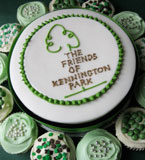 Award winning luxury Jamaica Fruit Cake with icing topper, surrounded by vanilla cupcakes. All made with gluten free ingredients