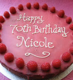 Raspberry & Almond Cake, made with organic ground almonds and rapeseed oil and fresh berries, with a thin raspberry glacé icing. All ingredients gluten-free and dairy-free. Can be delivered by hand in London