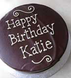 A gluten-free chocolate and almond cake made with organic dark Fairtrade chocolate, organic ground almonds and Appleton Jamaica Rum, with a dash of almond essence. Contains ground almonds and wheat free flour. Covered in dark chocolate ganache. Can be decorated. Piped message shown here is organic white chocolate. Delivery in London 