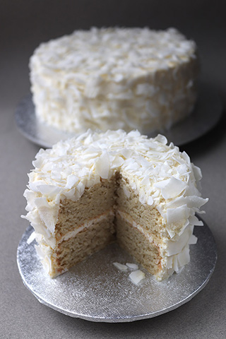 Gluten free sugar free Coconut & Vanilla Cake, made with organic ground almonds and coconut. Perfect if you're avoiding sugar, this flour free cake is delicately sweetened with xylitol, and contains no added sugar. Filled and frosted with mascarpone and covered with organic coconut chips, this is a gluten-free, sugar-free, flour-free cake