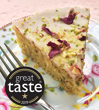 Six delicious glutenfree cakes to choose from. In the picture, a slice of award-winning Lemon & Pistachio Cake. All ingredients gluten free. Delivery in London, can also be posted