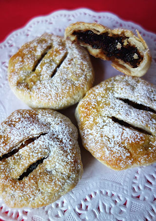 Gluten-free, dairy-free mince pies. Made with Silly Yak puff pastry. Filled with organic mincemeat mixed with Jamaica Rum and grated Bramley apple. All ingredients gluten free and dairy free. Can be delivered by post in the UK, delivery by hand available in London