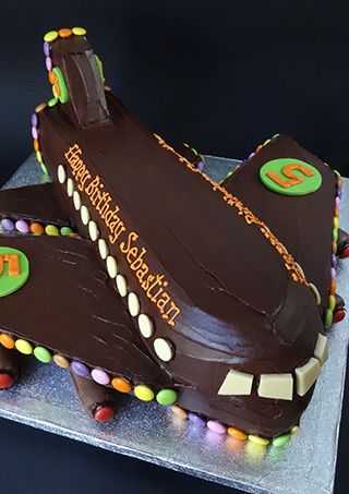 Chocolate Aeroplane Cake made with organic fairtrade gluten-free vanilla & chocolate sponge and covered in ganache, decorated with glutenfree chocolate beans. Hand delivery only, in London & the southeast