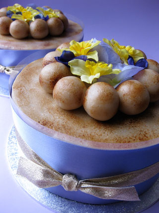 A zesty, gluten-free Simnel Cake for Easter, made with organic fruit, with a dash of almond liqueur, and topped with organic marzipan: eleven balls represent the apostles, but not Judas. With blue satin ribbon and gold lamé bow. Smaller cakes are wrapped in cellophane with posy of silk spring flowers, large cakes are decorated with silk spring flowers and come in a box. Delivery in London or by post to the rest of the UK 