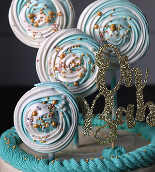 Gluten free celebration cakes – all shapes and flavours. This one, for a baby shower, is a Madagascar vanilla cake, filled with vanilla buttercream, and decorated with piped swirls and meringue lollipops. All ingredients gluten-free & lactose-free. Delivery in London & southeast