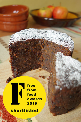 A moist, dark, vegan fruitcake made with gluten free, dairy free organic ingredients: vine fruit & citrus zests, Bramley apples and ground almonds, as well as Appleton Jamaica Rum. Lightly sweetened with organic dates, no added sugar. Comes with organic icing sugar to sprinkle before serving. All ingredients gluten-free and dairy-free