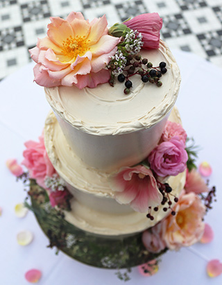 3-tier gluten-free Pandan Cake with Gula Melaka buttercream, decorated with edible flowers, for an intimate wedding at the Horniman Conservatory
