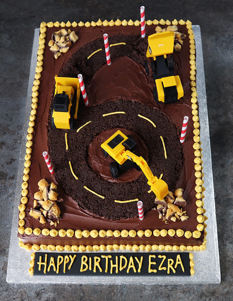 Gluten-free Construction Cake: gluten free chocolate & orange cake frosted with choc fudge buttercream and decorated with crushed freefrom Oreo biscuits & honeycomb, and construction toys. All ingredients glutenfree 