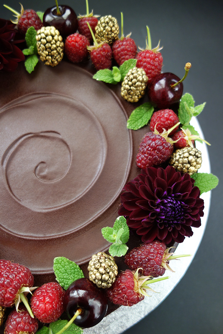 Gluten-free, dairy-free, sugar-free chocolate and almond wedding cake made with organic Fairtrade chocolate, organic ground almonds and Appleton Jamaica Rum, with a dash of almond essence. Covered in sugar-free chocolate ganache and decorated with fresh berries, cherries and organic edible flowers