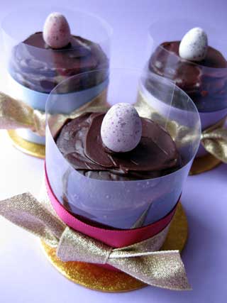 For Easter, a luscious gluten-free chocolate truffle cake, just for one. Made with organic ground hazelnuts and dark Fairtrade organic chocolate and a dash of hazelnut liqueur and sweetened with organic hazelnut & chocolate spread. Wheat-free and gluten free, made without flour. Topped with organic dark chocolate ganache and a sugar-coated mini egg. Wrapped with a satin ribbon and tied with a gold lamé bow. A little chocolate treat for Easter, posted to your door, in London and the UK